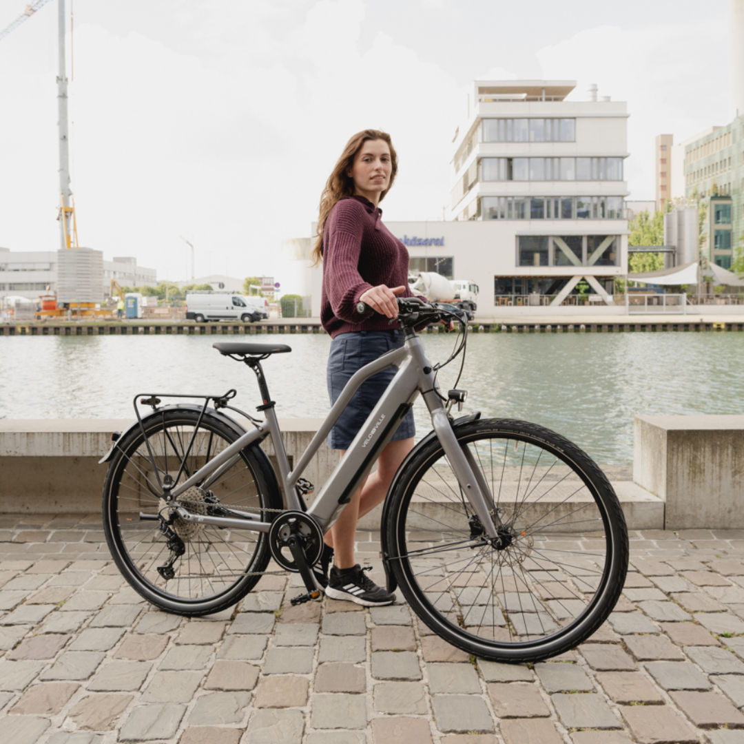 Une femme avec son vélo électrique de ville