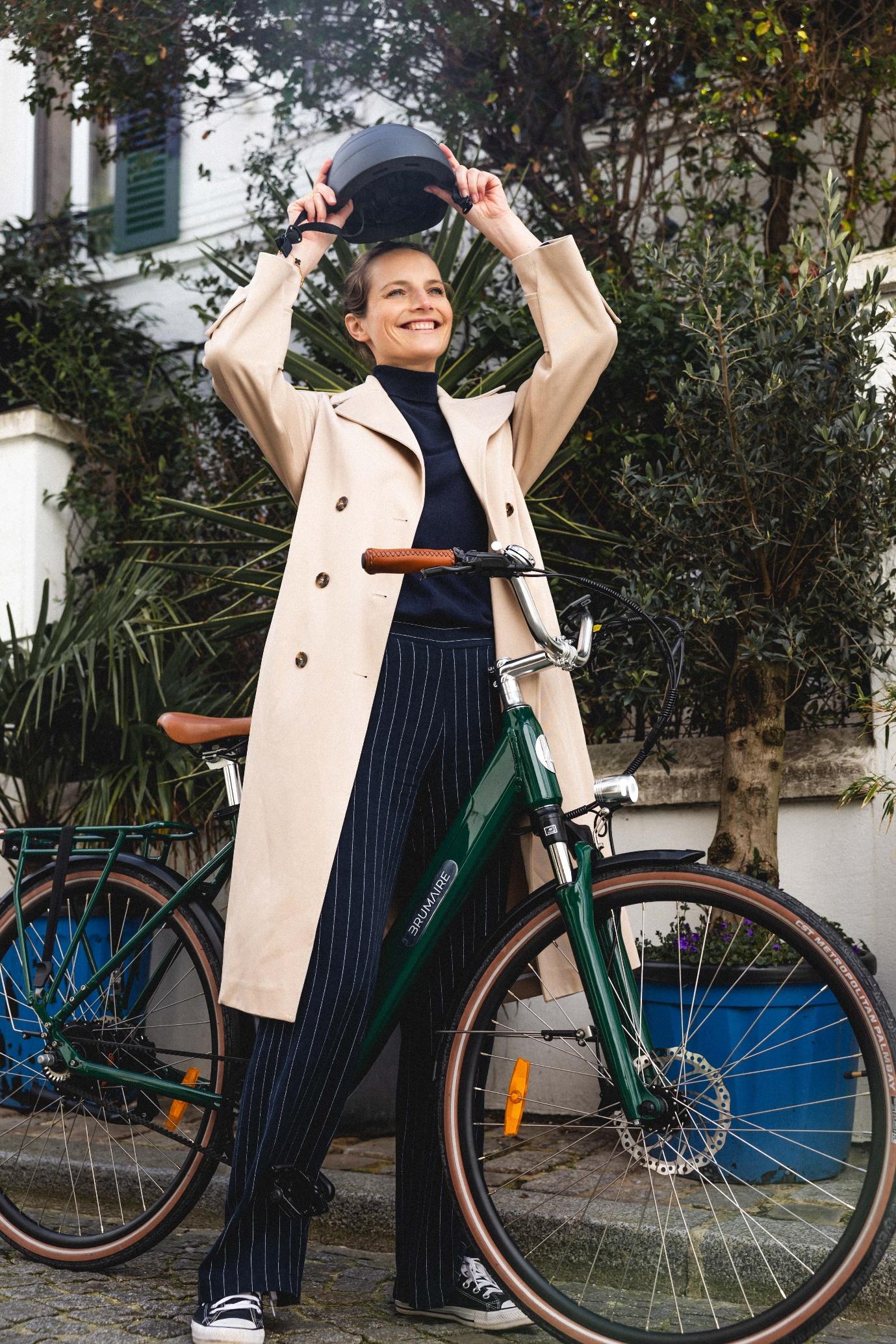 Une femme qui enleve son casque sur un vélo électrique